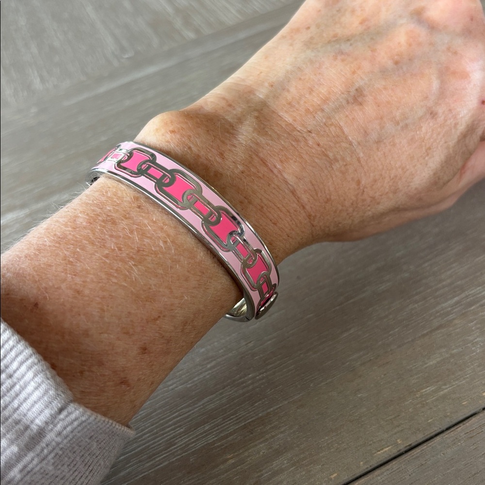 Halcyon Days Chain enamel hinged bangle in a pink and gold colorway.